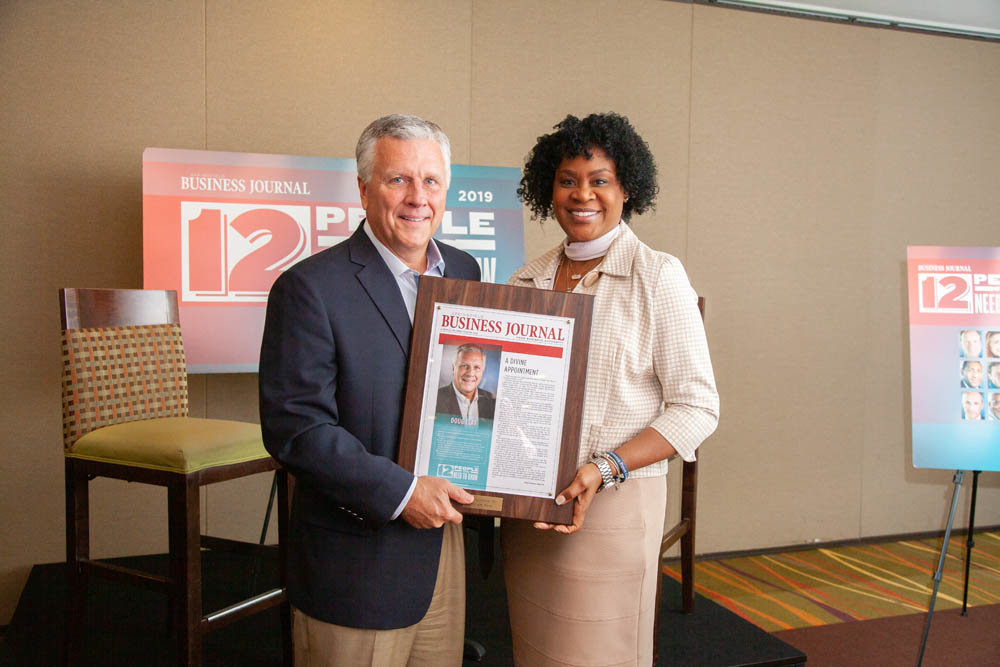 BUSINESS AND FAITH
During the 12 People You Need to Know live interview Aug. 20, Assemblies of God General Superintendent Doug Clay spoke to the intersection of business, faith and culture. AG has grown to a $20 billion organization in terms of assets and monies under management. Above, Clay receives a plaque from Felicia Morgan of event sponsor Arvest Bank.